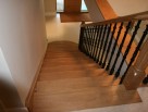 Straight wooden staircase with metal balusters