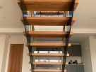 Steel staircase with timber treads and glass balustrades